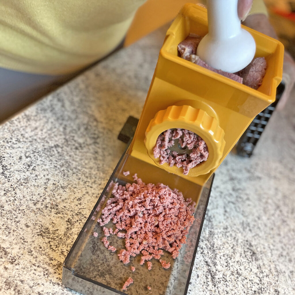 Put cured beef brisket through a meat grinder | Cook for 2!